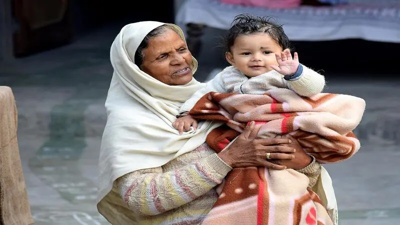 How to Handle Toddler Tantrums (Without Losing Your Mind) Indian grandparent sitting warmly with a toddler at a family gathering