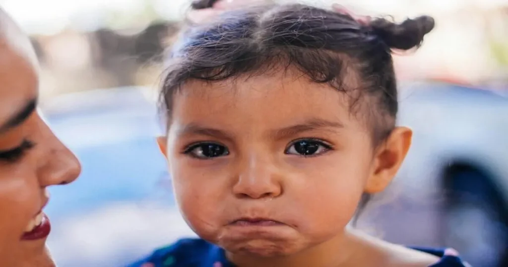 How to handle toddler tantrums: parent comforting an upset toddler