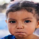 How to handle toddler tantrums: parent comforting an upset toddler