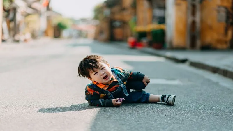 How to Handle Toddler Tantrums (Without Losing Your Mind) Toddler mid-tantrum crying on the floor at public place